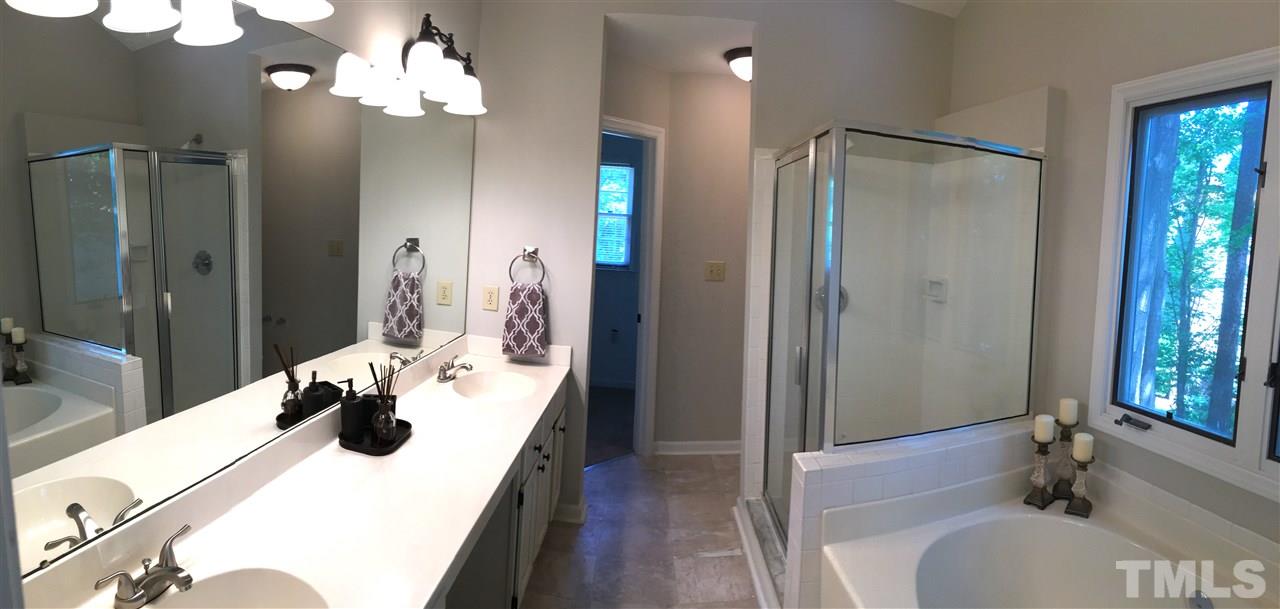 4821 Knightsbridge Way Raleigh, NC 27604 - Photo 11 of 22 a bathroom with a tub sink and mirror