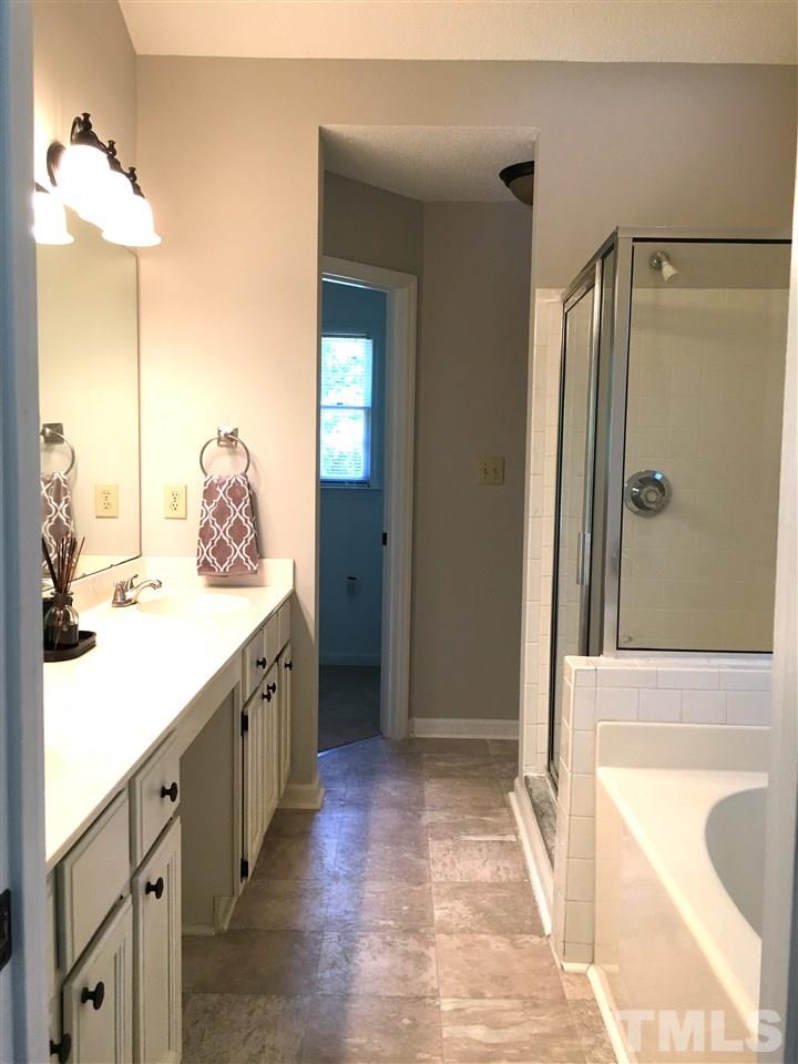 4821 Knightsbridge Way Raleigh, NC 27604 - Photo 12 of 22 a spacious bathroom with a double vanity sink and mirror