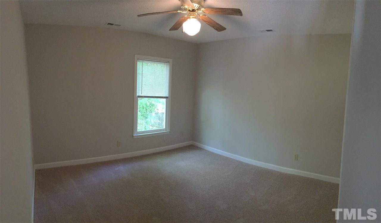 4821 Knightsbridge Way Raleigh, NC 27604 - Photo 15 of 22 an empty room with a window and a fan