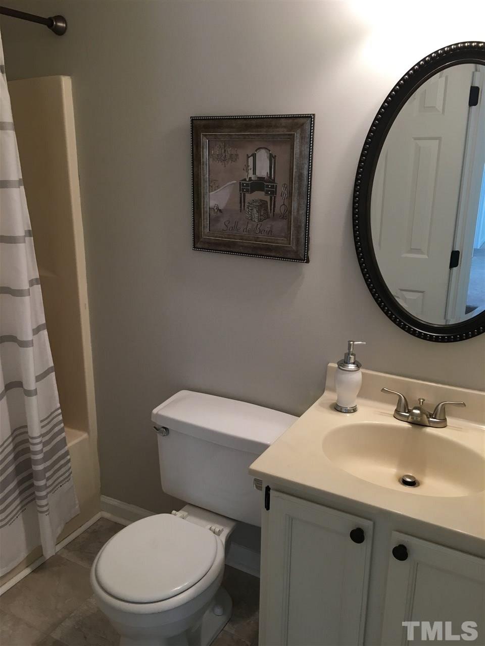 4821 Knightsbridge Way Raleigh, NC 27604 - Photo 19 of 22 a bathroom with a toilet a sink and mirror