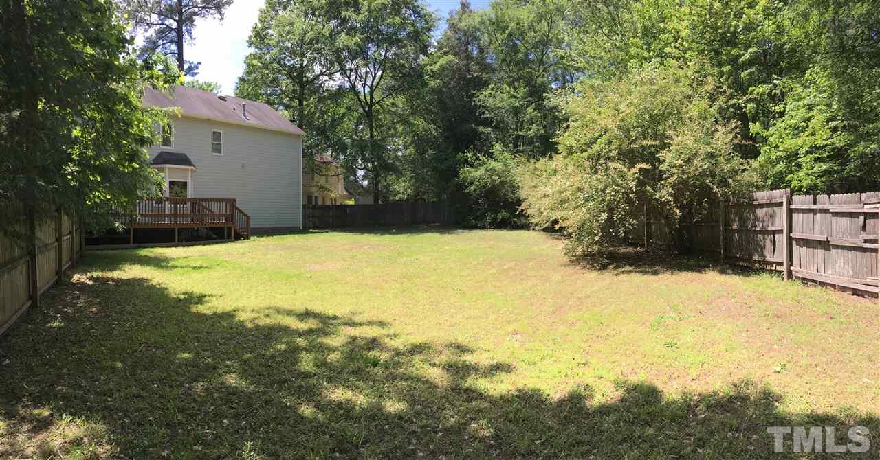 4821 Knightsbridge Way Raleigh, NC 27604 - Photo 21 of 22 a view of back yard of the house along with trees
