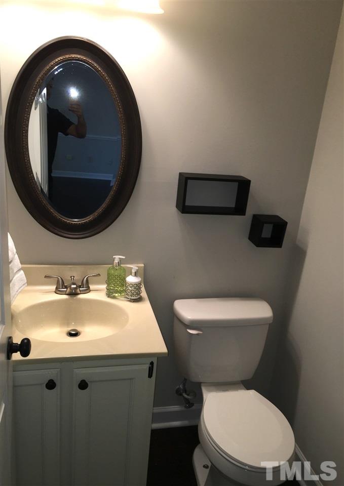 4821 Knightsbridge Way Raleigh, NC 27604 - Photo 6 of 22 a bathroom with a toilet and a sink