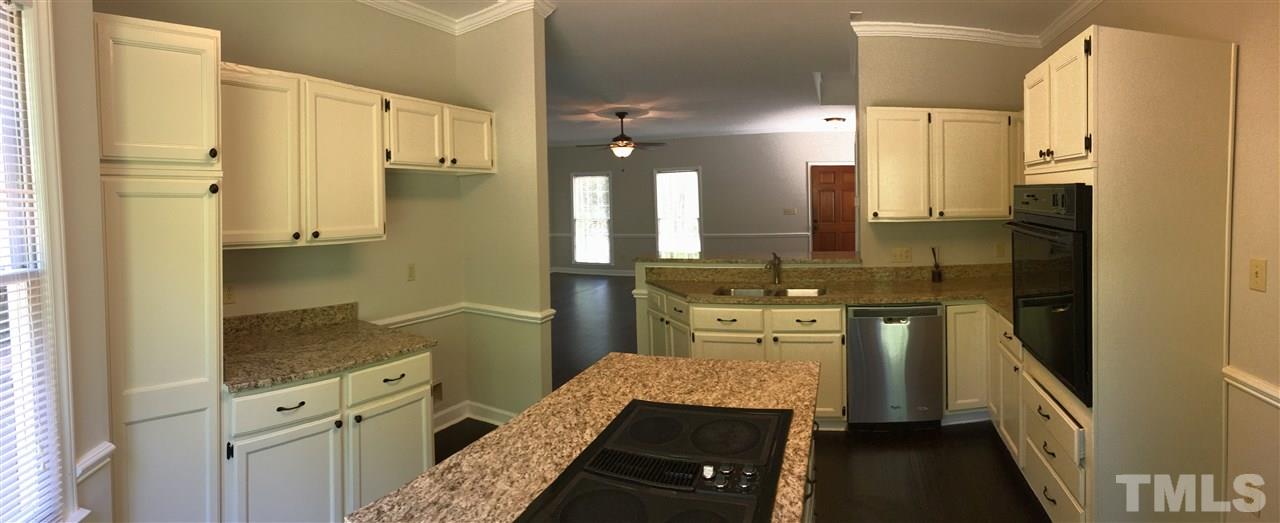 4821 Knightsbridge Way Raleigh, NC 27604 - Photo 7 of 22 a kitchen with a refrigerator and a stove