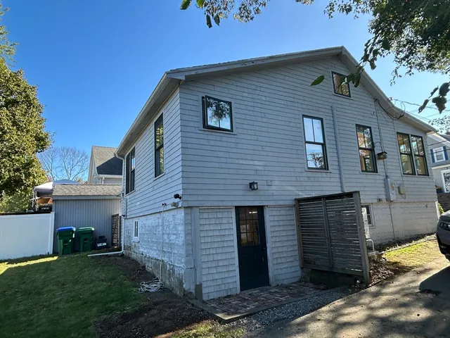 a brick house with a small yard and a large window