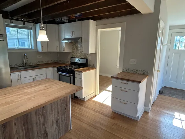 a kitchen with a stove a sink and a refrigerator