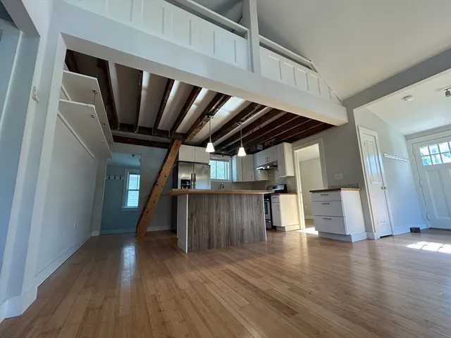 a view of livingroom with wooden floor and stairs