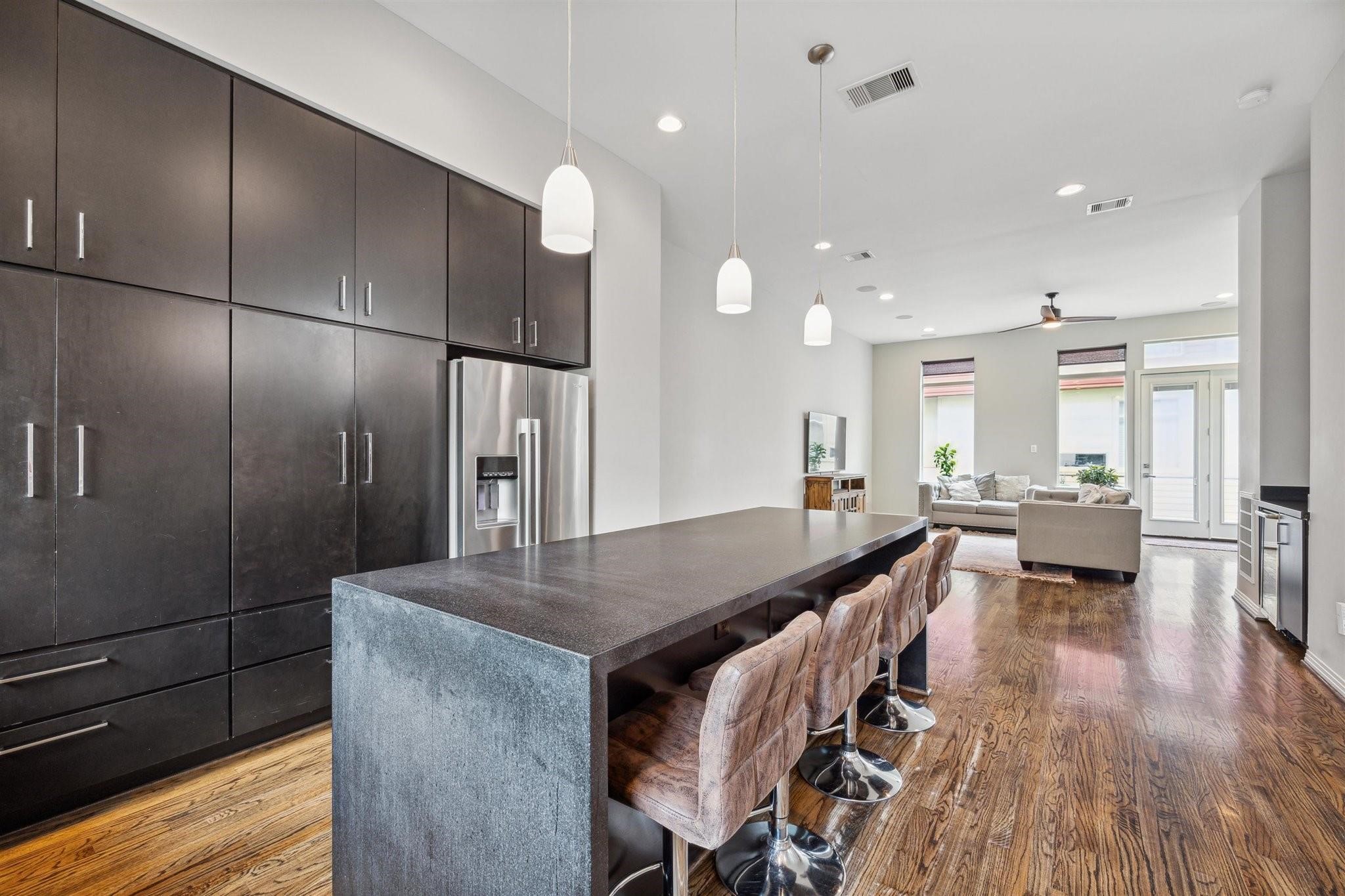 1630 Dennis Street Houston, TX 77004 - Photo 16 of 33 a open kitchen with stainless steel appliances granite countertop a sink a stove and refrigerator