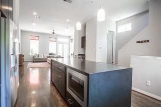 1630 Dennis Street Houston, TX 77004 - Photo 17 of 33 a view of a kitchen with kitchen island a sink wooden floor and a large window