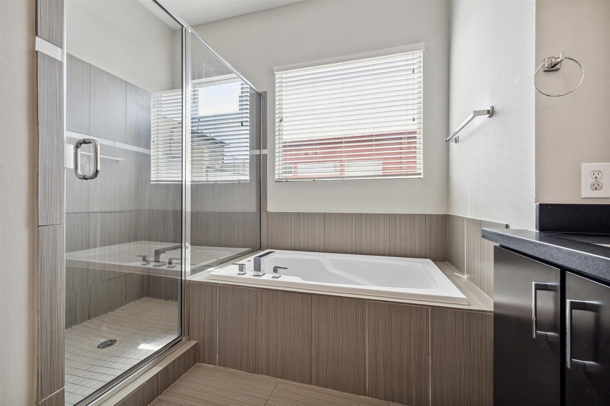 1630 Dennis Street Houston, TX 77004 - Photo 26 of 33 a bathroom with a tub a sink and a large window