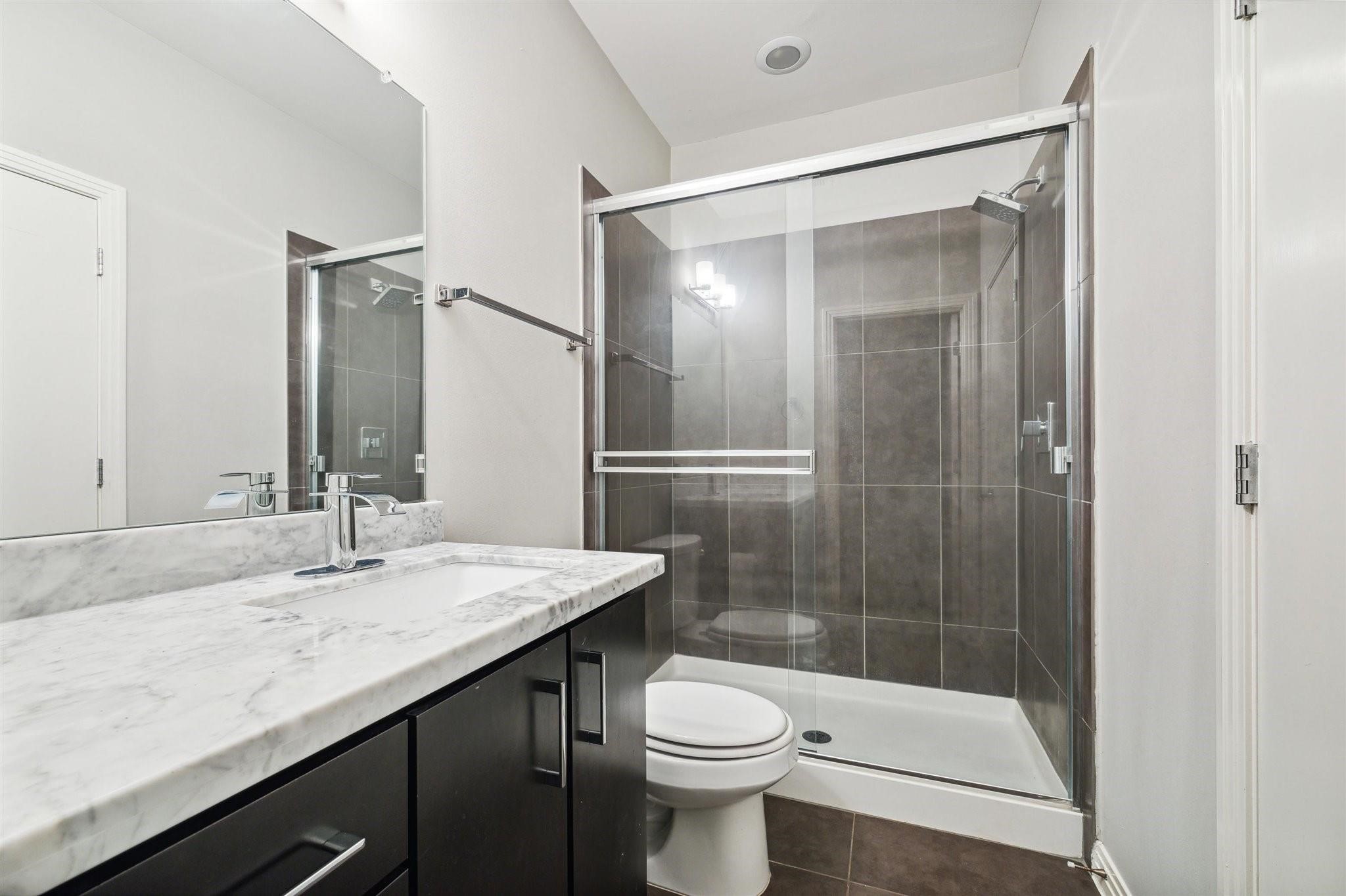 1630 Dennis Street Houston, TX 77004 - Photo 7 of 33 a bathroom with a sink a toilet and shower