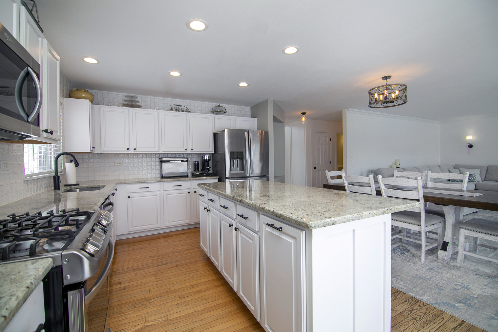 1675 Rosehall Lane Elgin, IL 60123 - Photo 16 of 49 a kitchen with stainless steel appliances granite countertop a stove top oven a sink a counter top space and cabinets