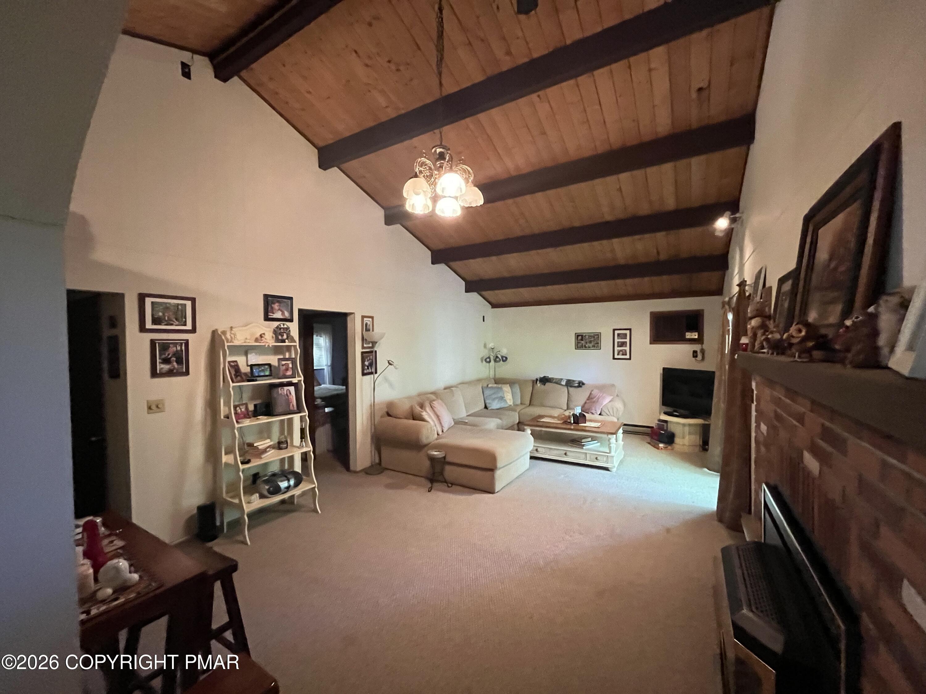 5970 Decker Road Bushkill, PA 18324 - Photo 17 of 26 a living room with furniture a flat screen tv and a refrigerator