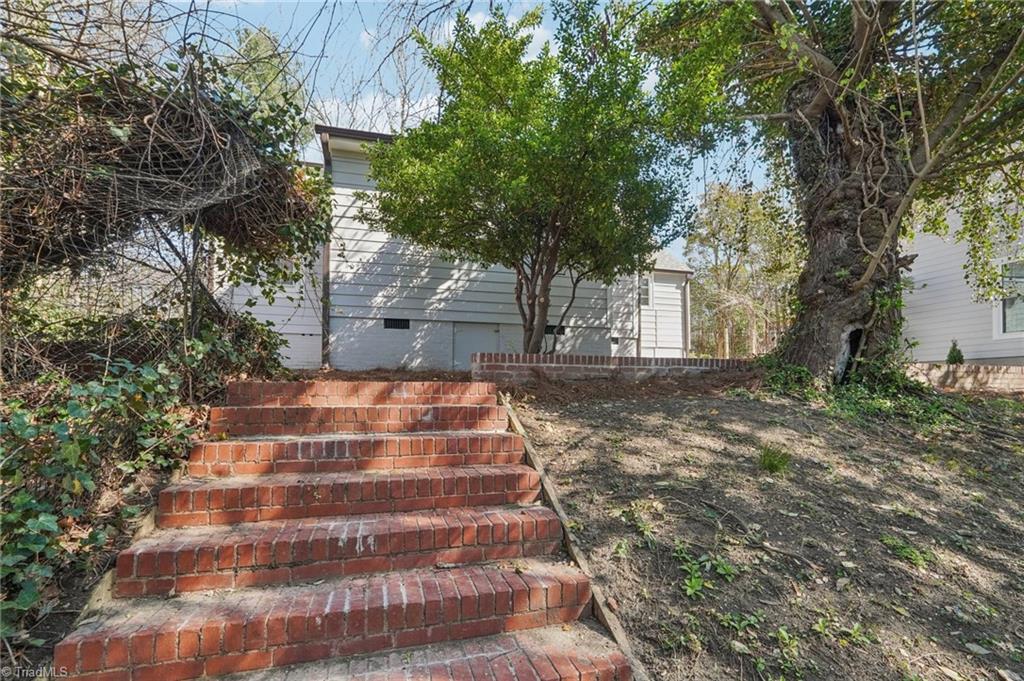 907 Sunset Drive High Point, NC 27262 - Photo 43 of 50 Steps through the canopy of trees to the beautiful backyard space