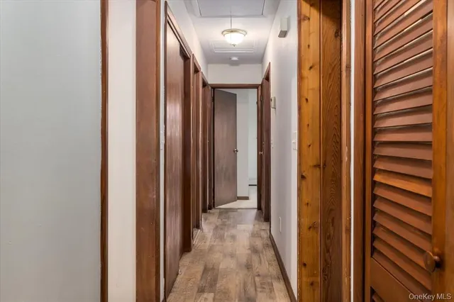 a view of a hallway with wooden floor and entryway