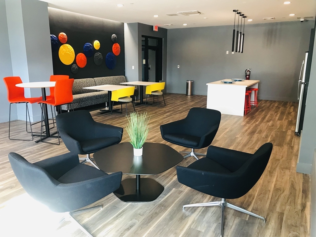 466 River Street, Unit 528 Boston, MA 02126 - Photo 15 of 19 a living room with furniture and flat screen tv