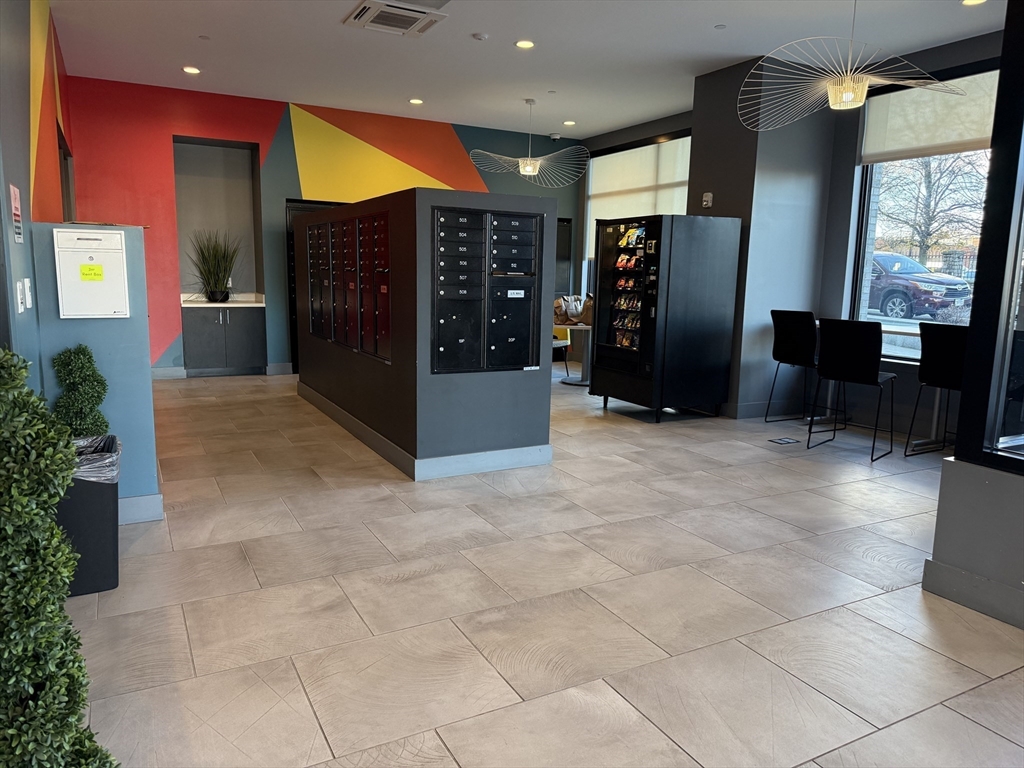 466 River Street, Unit 528 Boston, MA 02126 - Photo 17 of 19 a view of a lobby with furniture and a potted plant