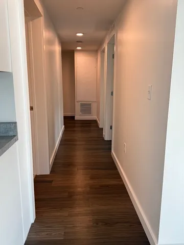 a view of a hallway with wooden floor