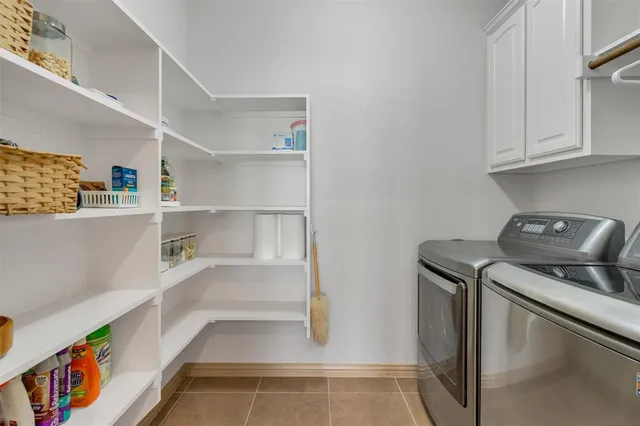a kitchen with kitchen island white cabinets and refrigerator