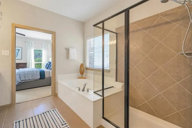 a bathroom with a tub shower and sink