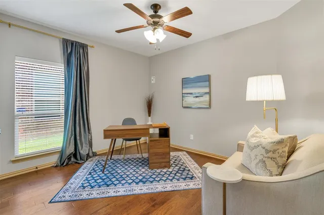 a bedroom with a large bed and a chandelier fan