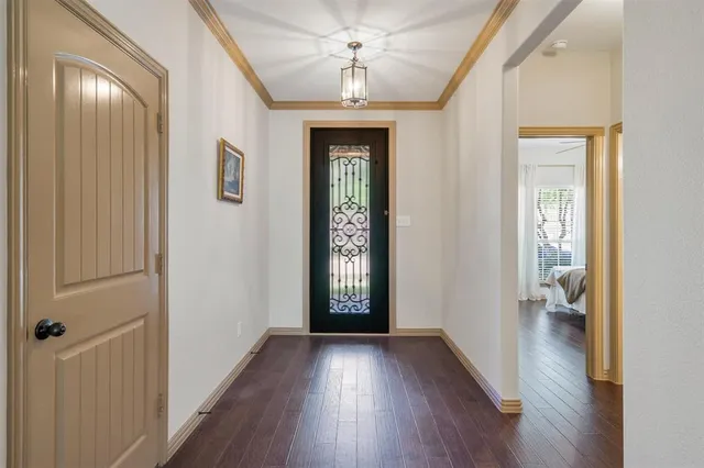 a view of a hallway with wooden floor and a living room
