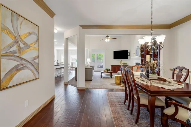 a view of a dining room with furniture and chandelier