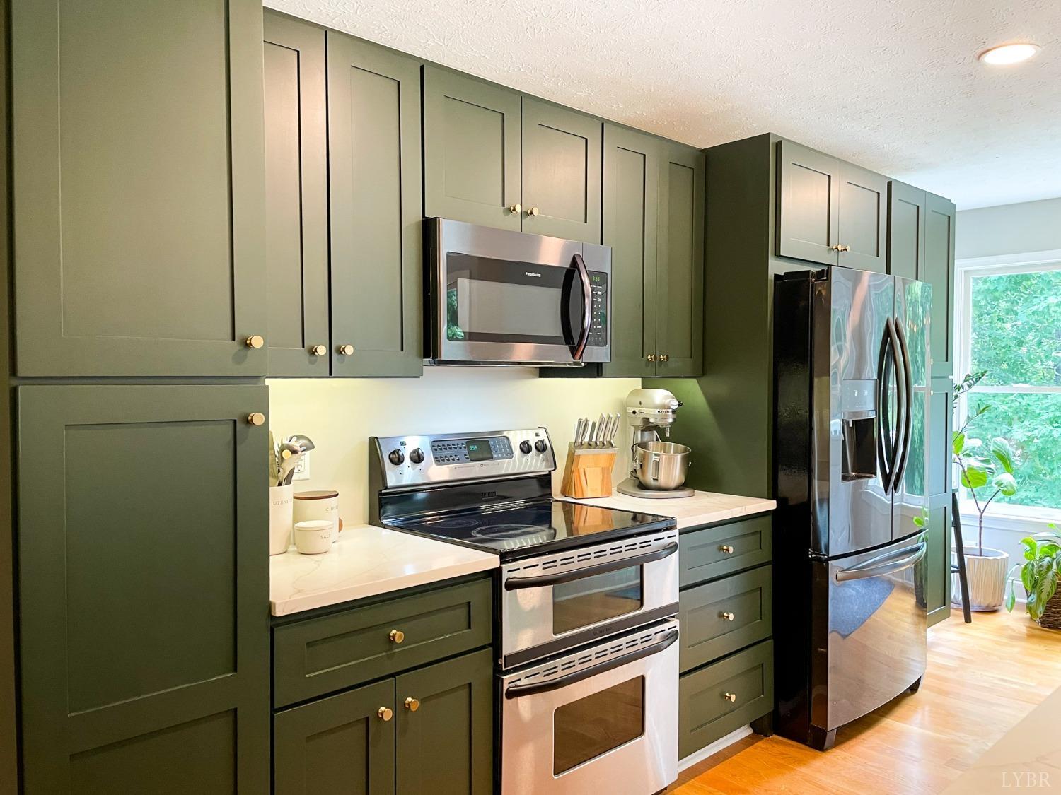 4512 Roaring Run Road Goode, VA 24556 - Photo 14 of 54 a kitchen with stainless steel appliances granite countertop a refrigerator and a sink