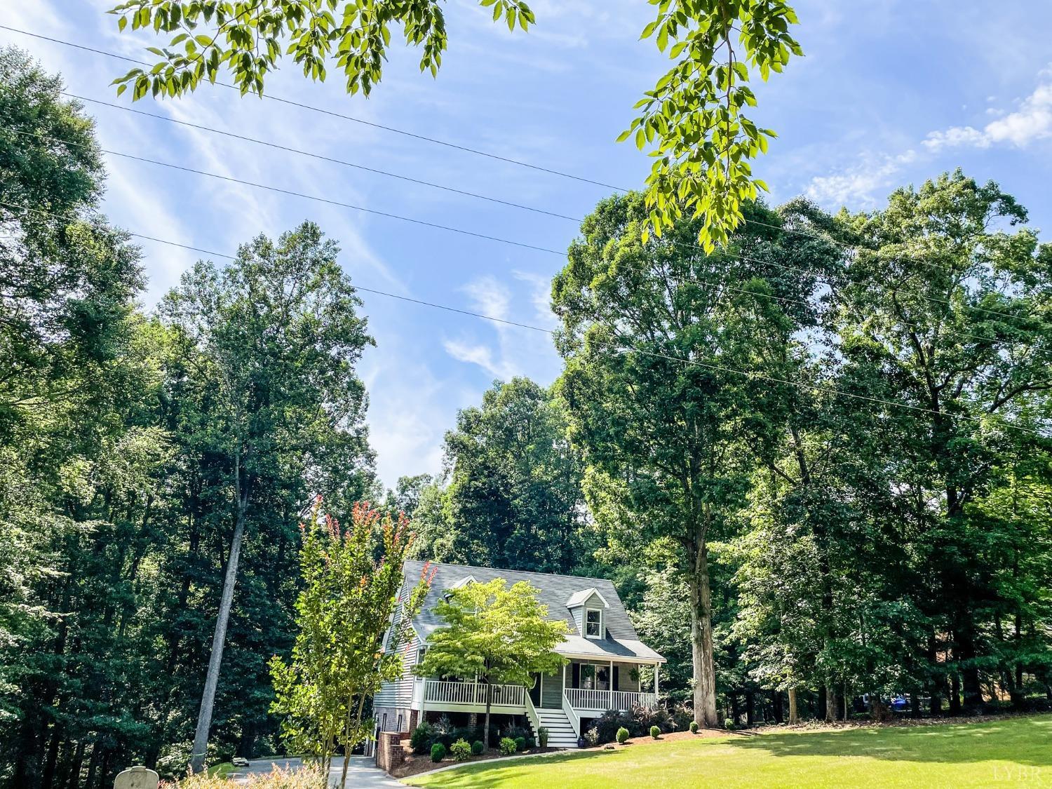 4512 Roaring Run Road Goode, VA 24556 - Photo 2 of 54 a view of outdoor space with garden and tall trees