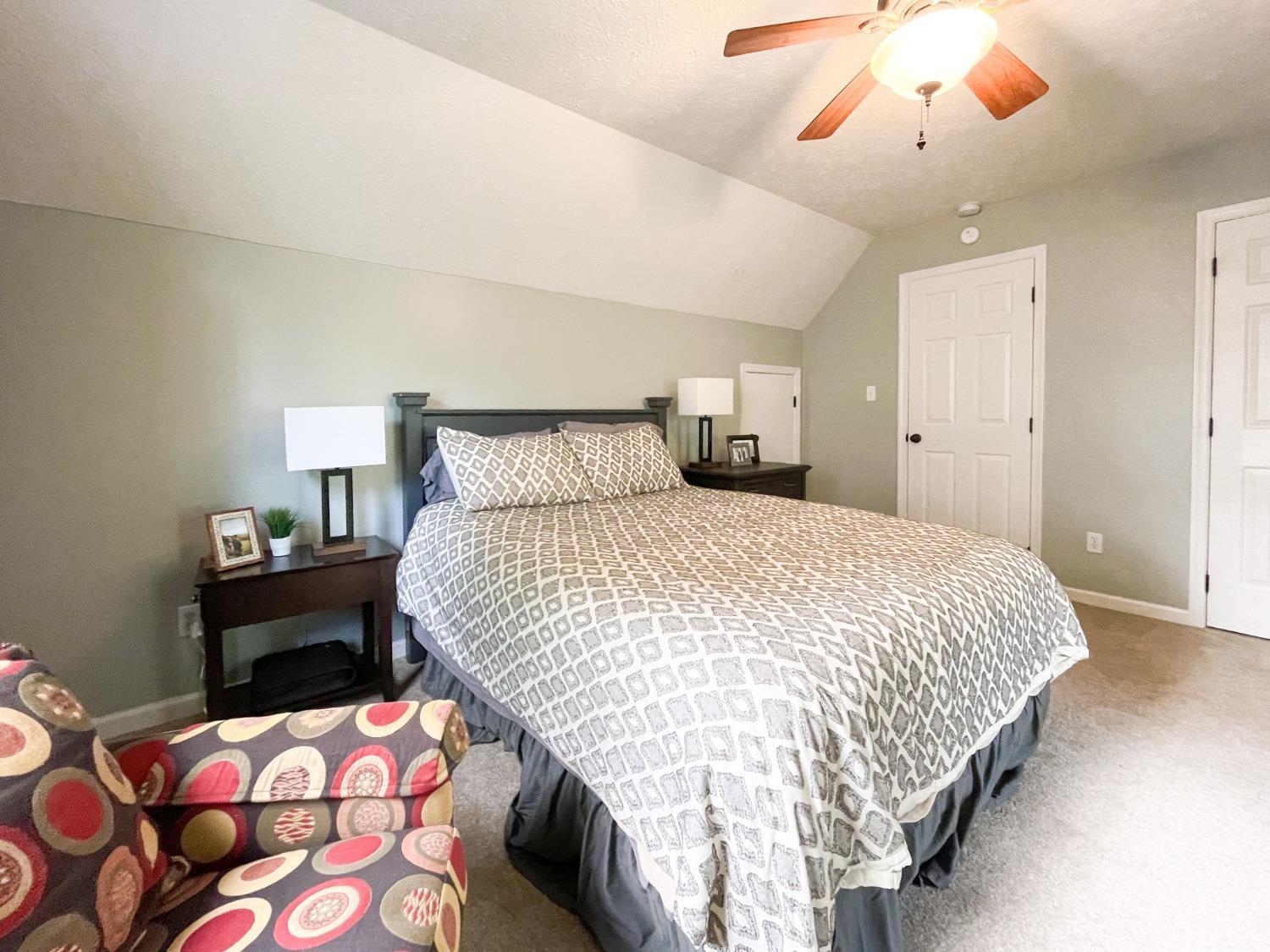 4512 Roaring Run Road Goode, VA 24556 - Photo 42 of 54 a bedroom with a bed and a chandelier