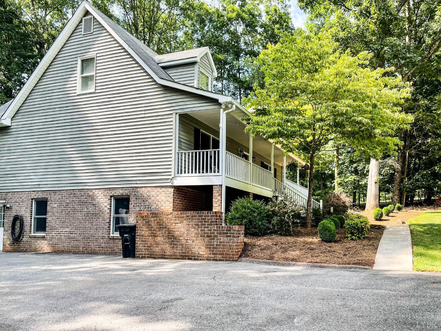 4512 Roaring Run Road Goode, VA 24556 - Photo 54 of 54 a front view of a house with a yard and garage