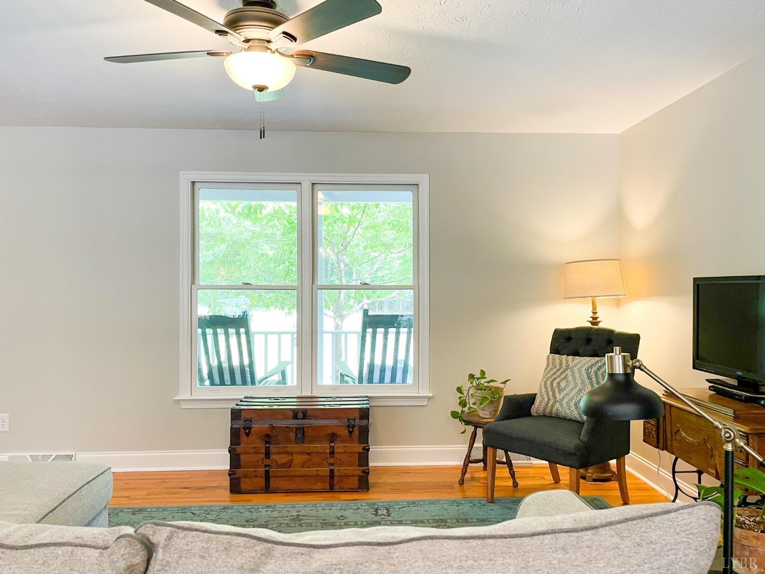 4512 Roaring Run Road Goode, VA 24556 - Photo 10 of 54 a living room with furniture and a flat screen tv