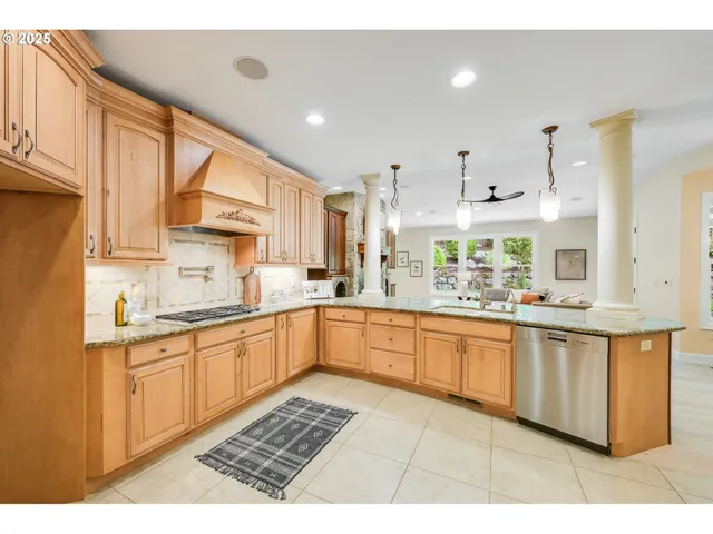 a kitchen with granite countertop a stove a sink and a granite counter tops