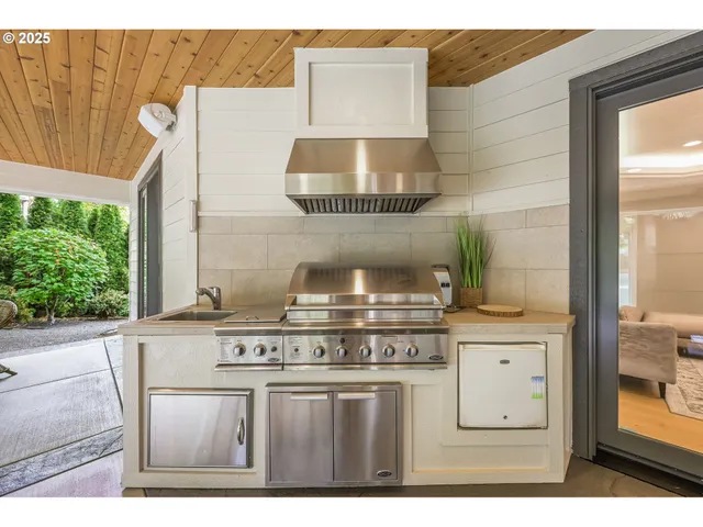 a view of a patio with table and chairs and potted plants
