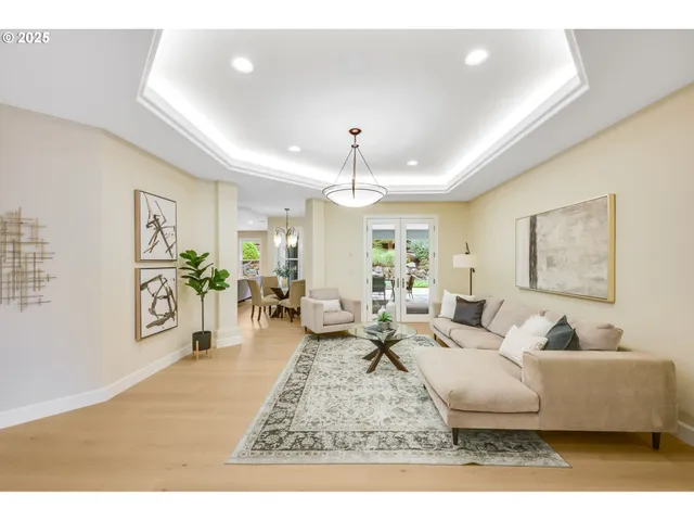 a living room with furniture and a chandelier