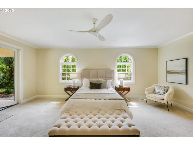 a bedroom with a large bed and a large window