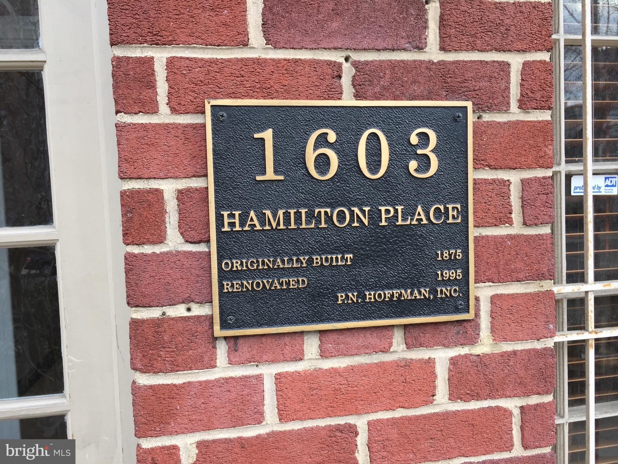 a sign broad on the brick wall