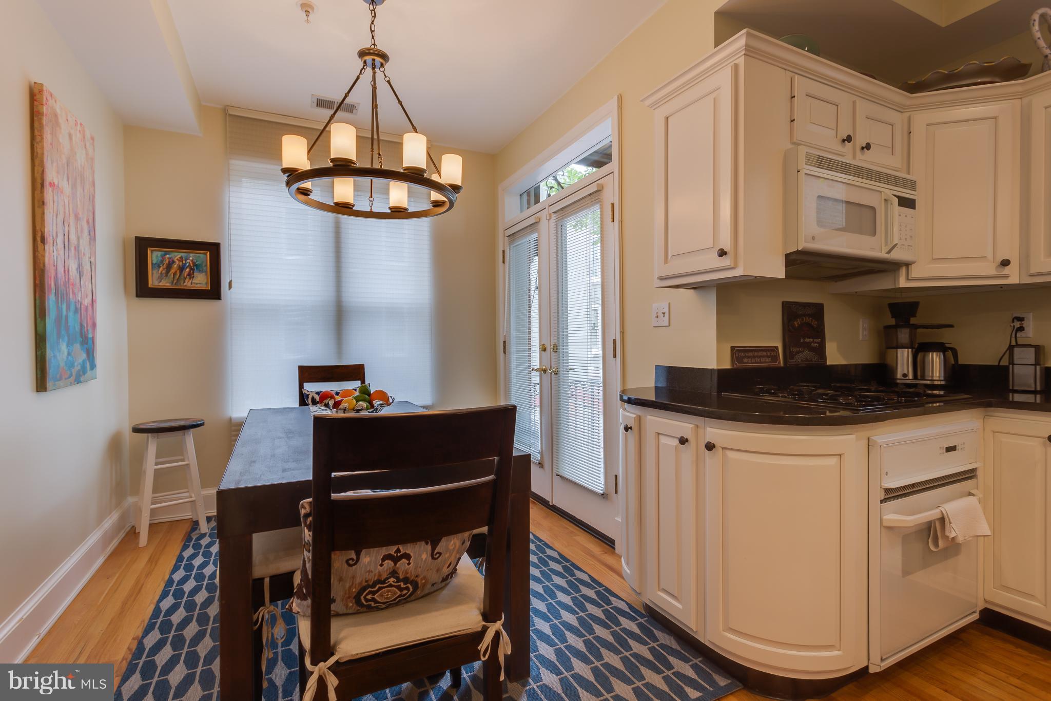 1603 16th Street Northwest, Unit 3 Washington, DC 20009 - Photo 12 of 30 a kitchen with stainless steel appliances granite countertop a stove and white cabinets