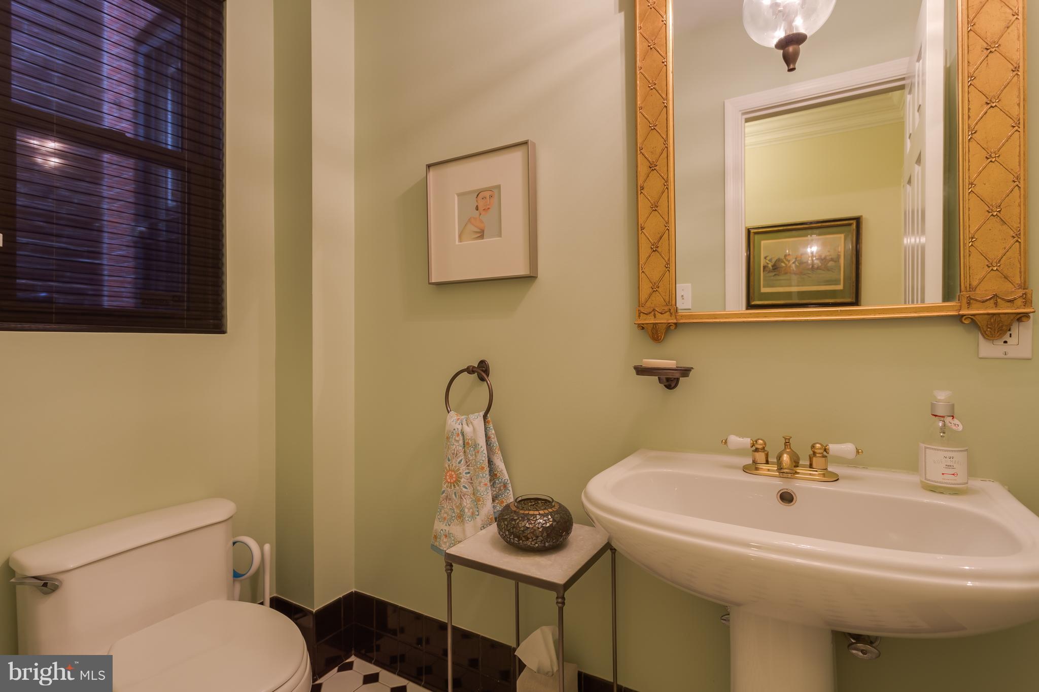 1603 16th Street Northwest, Unit 3 Washington, DC 20009 - Photo 26 of 30 a bathroom with a sink a toilet and mirror