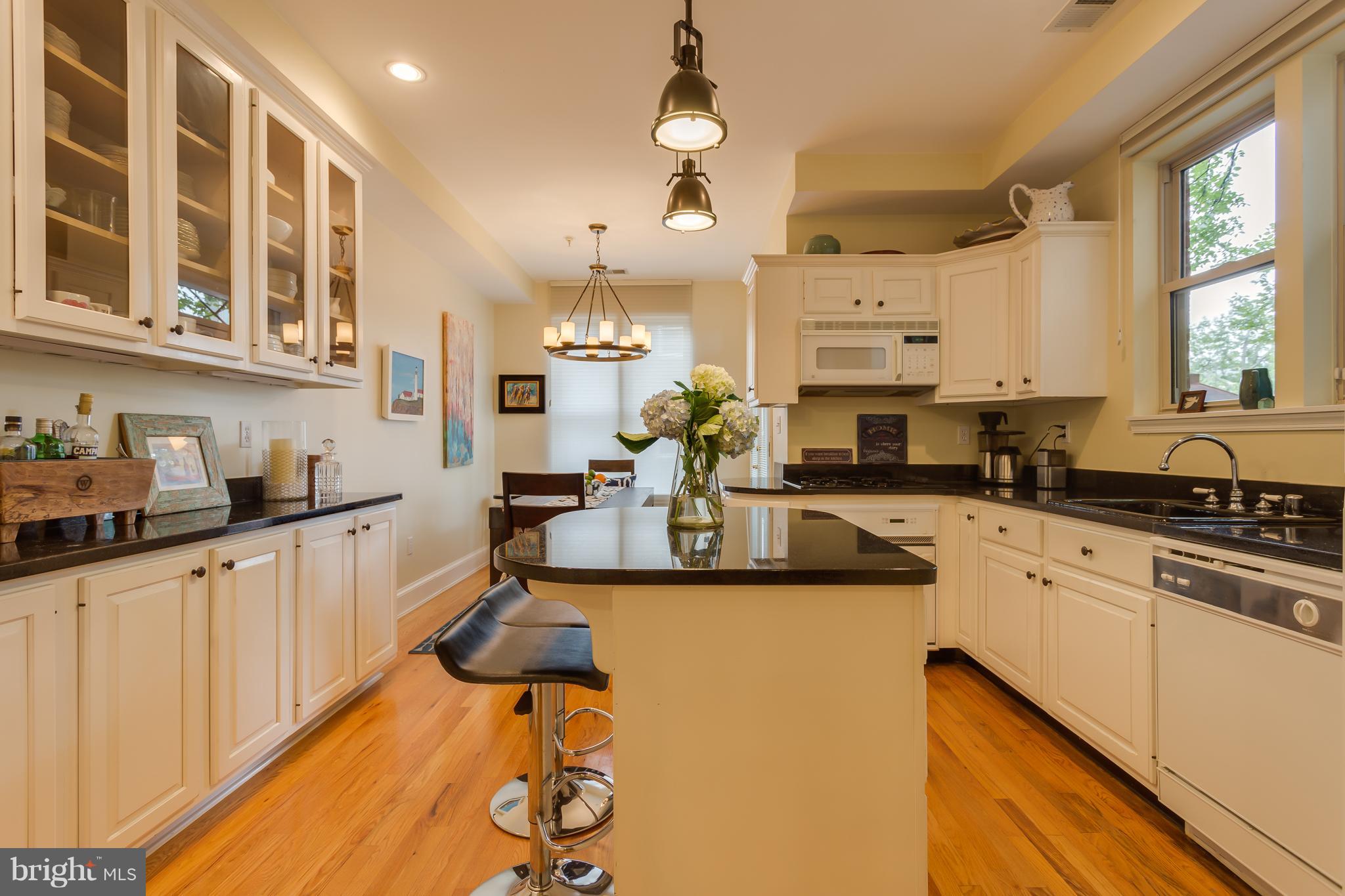 1603 16th Street Northwest, Unit 3 Washington, DC 20009 - Photo 6 of 30 a kitchen with stainless steel appliances kitchen island granite countertop a sink and cabinets