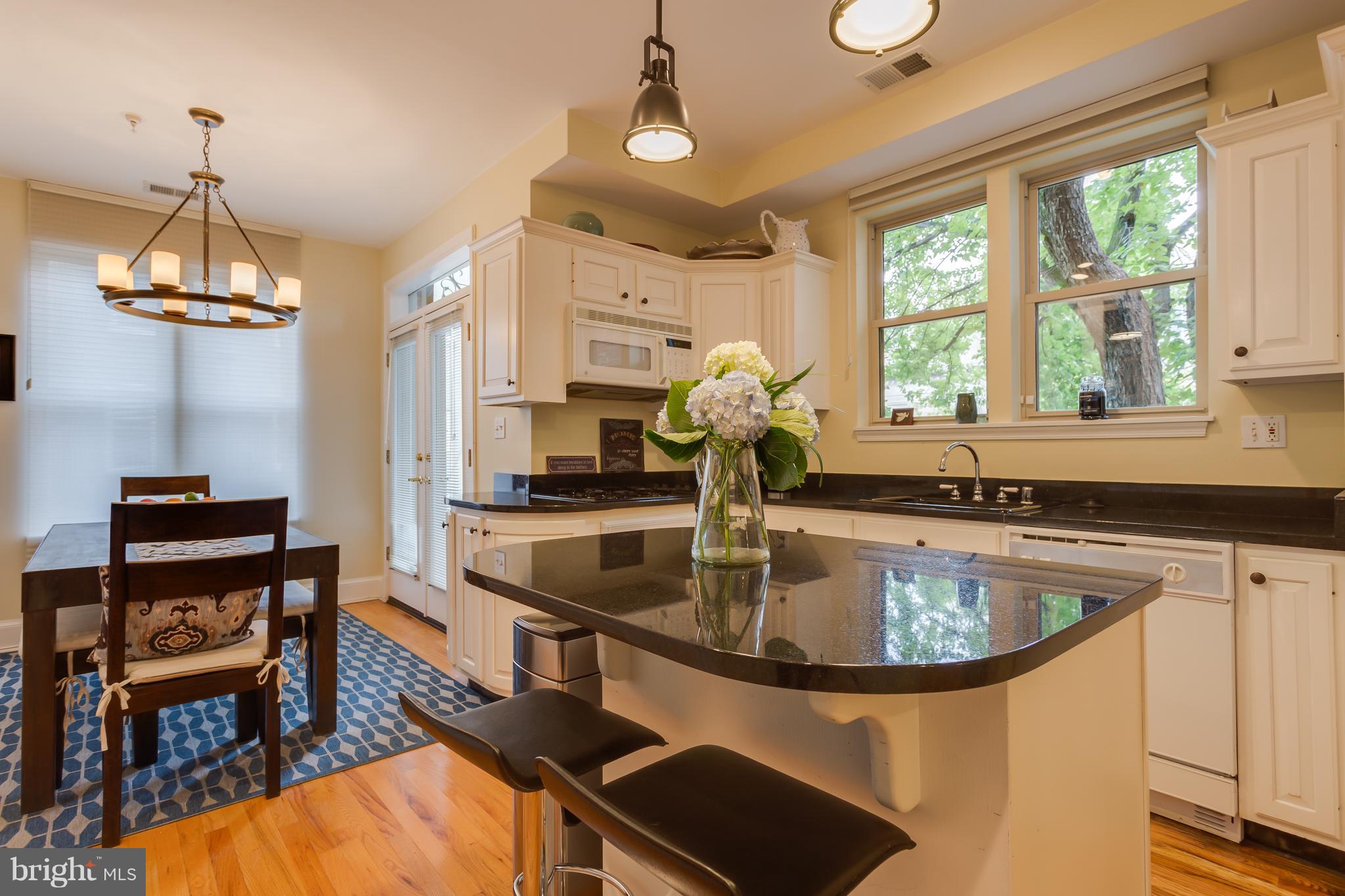 1603 16th Street Northwest, Unit 3 Washington, DC 20009 - Photo 8 of 30 a kitchen with stainless steel appliances granite countertop a sink a stove and a dining table