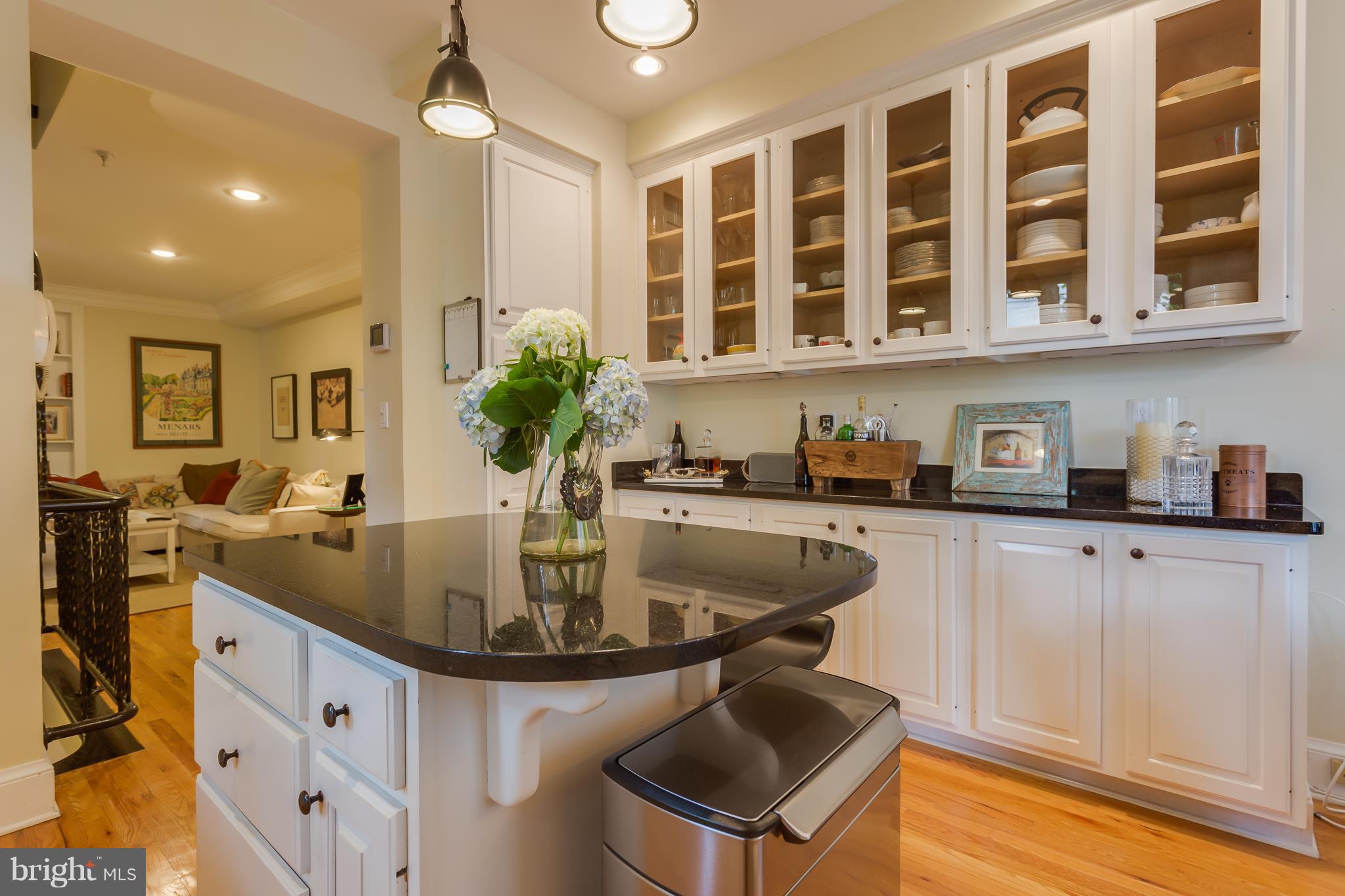 1603 16th Street Northwest, Unit 3 Washington, DC 20009 - Photo 9 of 30 a kitchen with kitchen island granite countertop a sink and cabinets