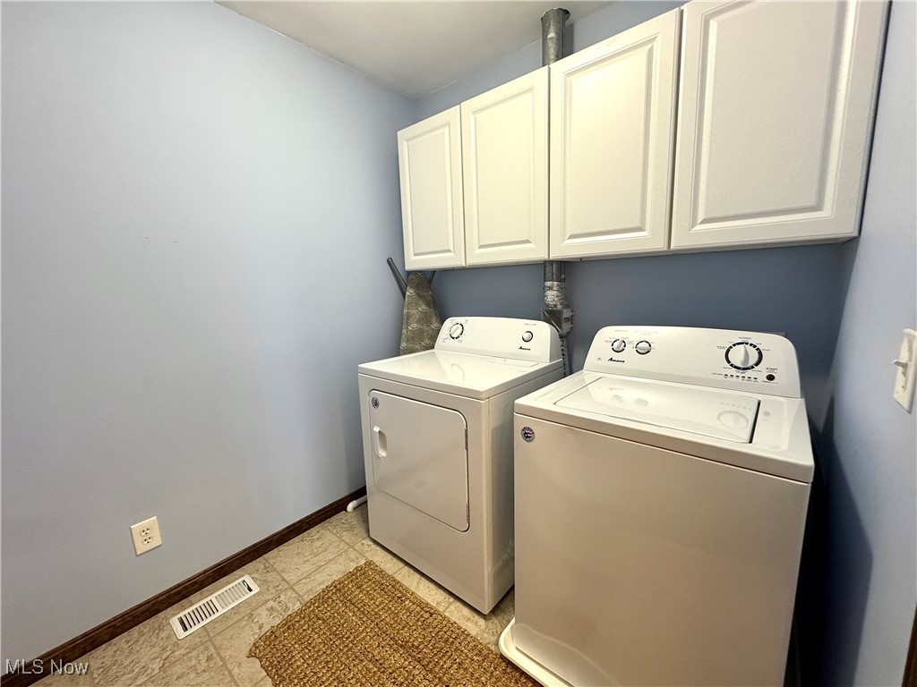 3450 Secrest Road Wooster, OH 44691 - Photo 30 of 34 Laundry room featuring washing machine and dryer, baseboards, cabinet space