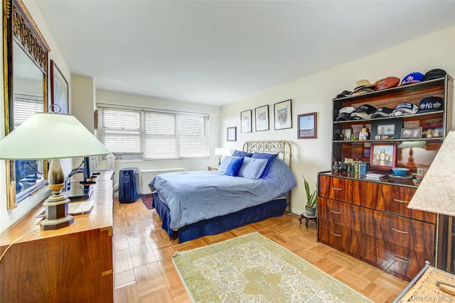 a bedroom with a large bed and a wooden floor