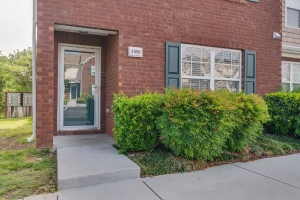 front view of a brick house with a yard