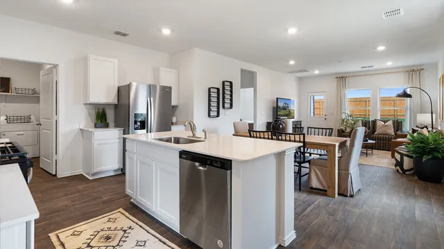 a kitchen with stainless steel appliances granite countertop a stove and a microwave