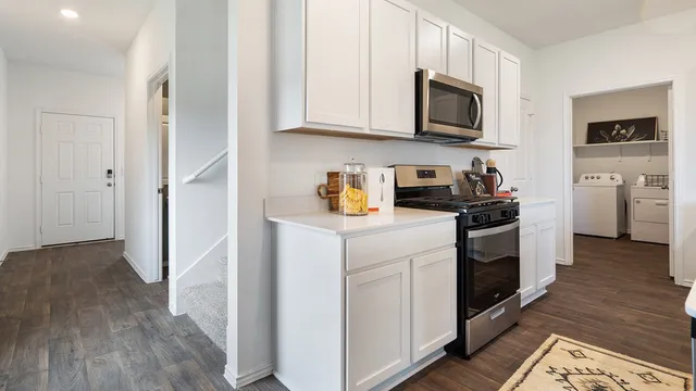 a kitchen with sink stove and refrigerator