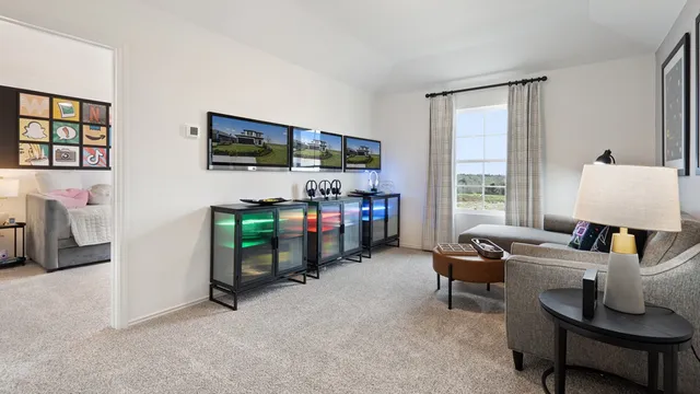 a bedroom with a bed a table and a large window