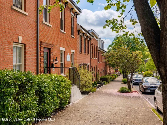 a view of a street with cars parked