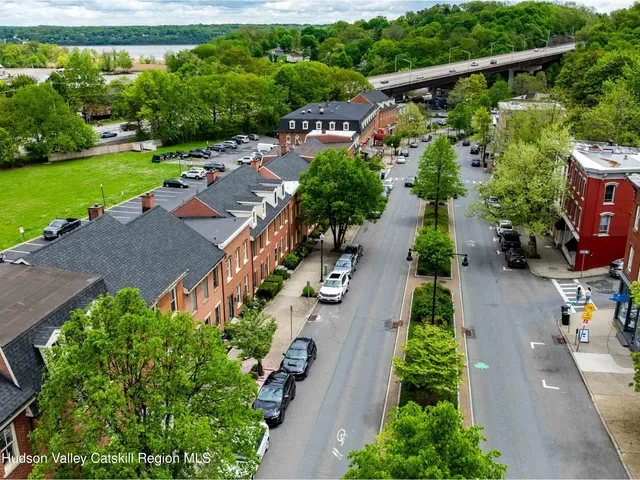 an aerial view of a house with outdoor space and street view