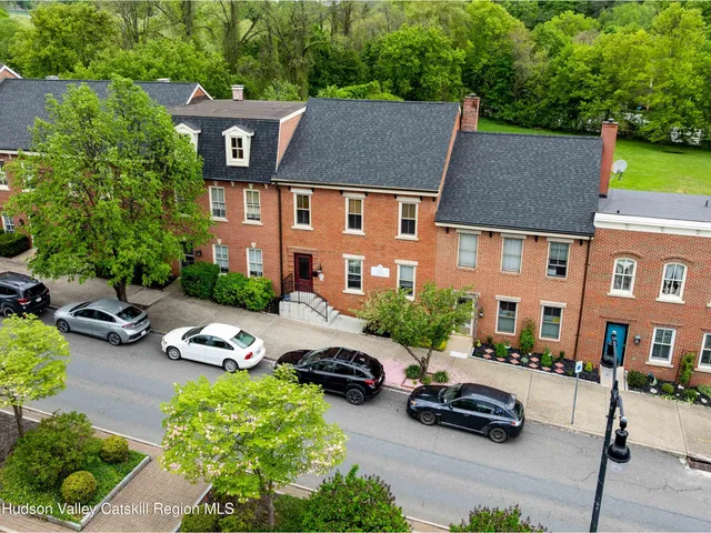 a car parked in front of a brick house